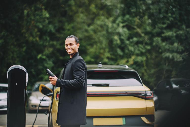 man-electric-car-vehicle-charging-station-driver-blog.jpg