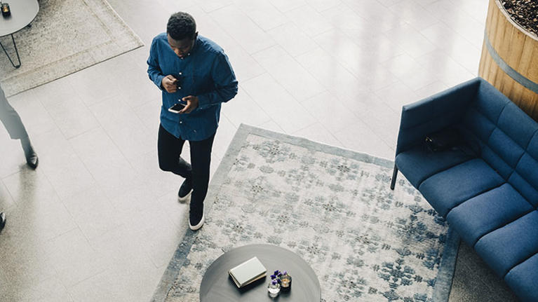 Person indoors looking at his phone